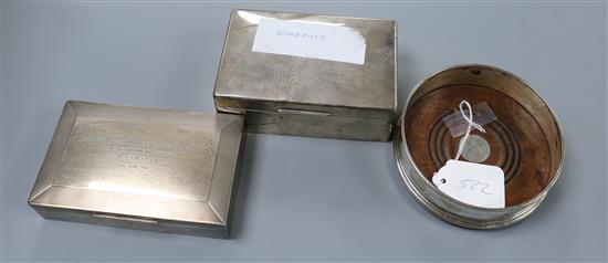 A modern silver wine coaster and two silver cigarette boxes.